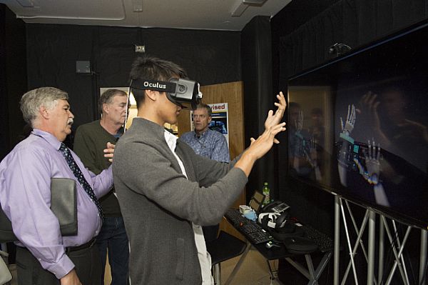 SAN DIEGO (June 5, 2015) Cristopher Ricario, an intern at the Battlespace Exploitation of Mixed Reality Lab at Space and Naval Warfare Systems Center Pacific (SPAWAR), demonstrates a mixed reality program to reporters during a media day. SPAWAR invited news reporters and family members of employees to see what top researchers, scientists and engineers are creating for today's Navy and fleet of the future during an open house June 5 - 6 celebrating 75 years of service. U.S. Navy photo by Mass Communication Specialist 2nd Class Antonio P. Turretto Ramos.