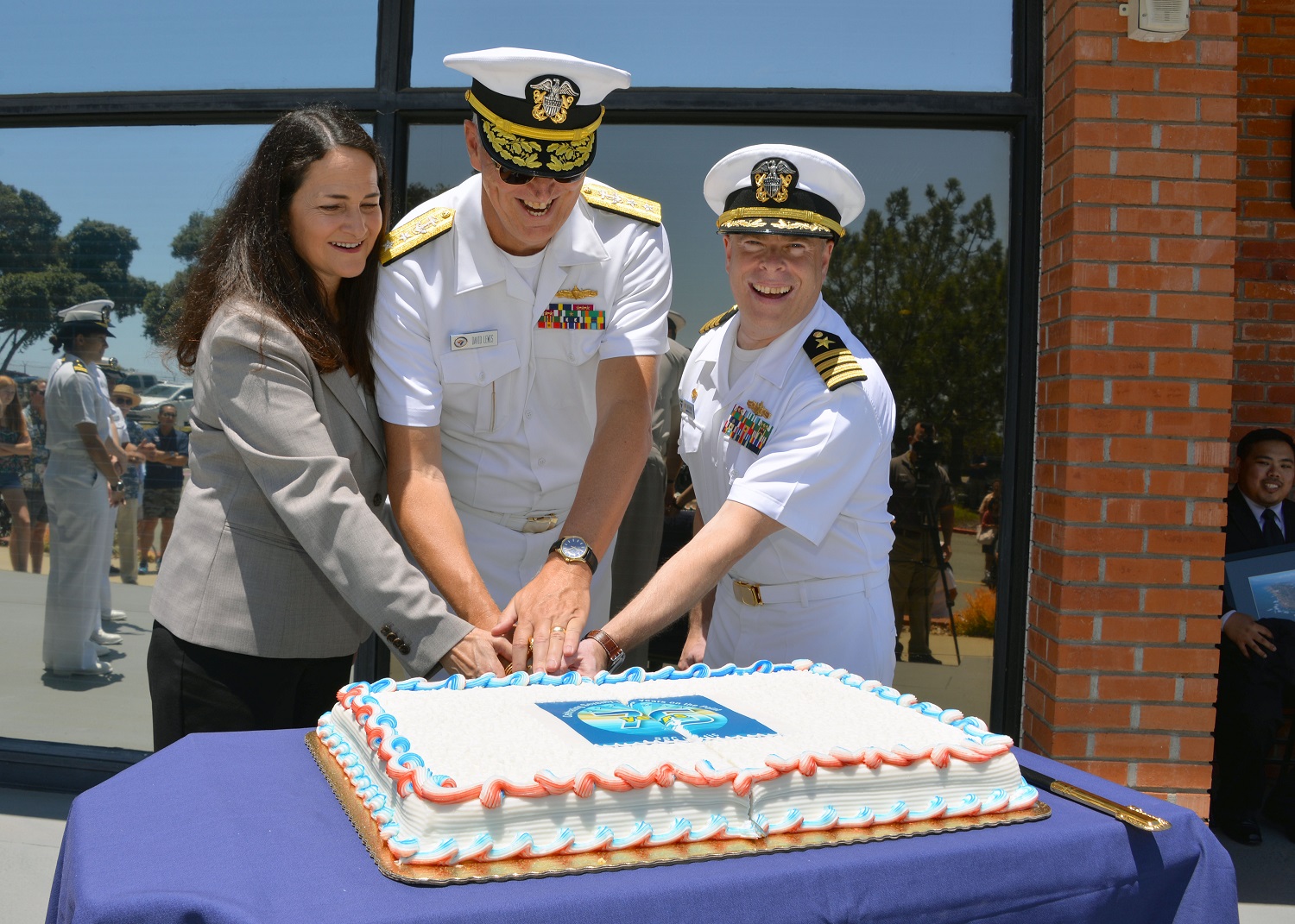 SAN DIEGO (June 6, 2015) SSC Pacific Executive Director Carmela Keeney, SPAWAR Commander Rear Adm. Dave Lewis, and SSC Pacific Commanding Officer Capt. Kurt Rothenhaus cut a ceremonial cake during events celebrating SSC Pacific's 75th Anniversary Open House. SSC Pacific celebrated its 75th anniversary by opening its facilities for demonstrations and site tours. U.S. Navy photo by Chief Mass Communication Specialist Ryan Valverde.