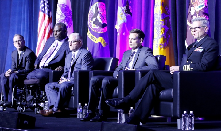 Navy Capt. Walter Greenhalgh (far right), National Intrepid Center of Excellence (NICoE) director, moderated a discussion on care after acute injuries during the “I Used to be a Wounded Warrior” session at the recent AMSUS (the Society of Federal Health Professionals) meeting near Washington, D.C. Joining him on the stage are (l-r) Rory Cooper, chair of the Department of Rehabilitation Science & Technology, and professor of Bioengineering, Physical Medicine & Rehab, and Orthopedic Surgery at the University of Pittsburgh; retired Army Col. Greg Gadson; Larry Miller, retired U.S. Navy physician assistant and now with the James A. Haley Veterans' Hospital in Tampa, Florida; and Dr. Paul Pasquina, retired Army doctor and currently chair of Physical Medicine and Rehabilitation at the Uniformed Services University of the Health Sciences (USU) in Bethesda, Maryland. 