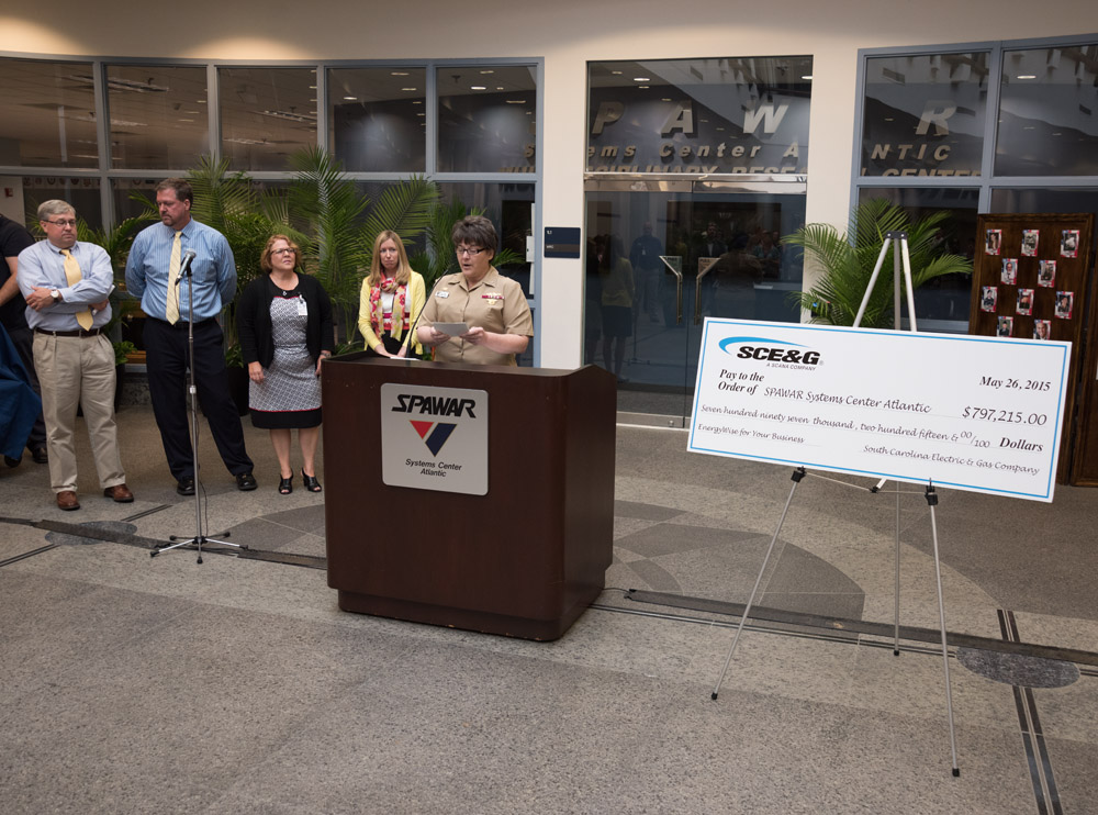 CHARLESTON, S.C.  (26MAY15) Captain Amy Burin, Commanding Officer of Space and Naval Warfare (SPAWAR) Systems Center (SSC) Atlantic, speaking at the ceremony to accept a rebate check from South Carolina Electric and Gas (SCE&G) in the amount of $797,215 May 26 at the Naval Weapons Station - Joint Base Charleston. The check is a result of successful energy savings rebate initiatives under SSC Atlantic's Energy Savings Performance Contract (ESPC) and SCE&G's EnergyWise for your Business program. U.S. Navy photo by Joe Bullinger.