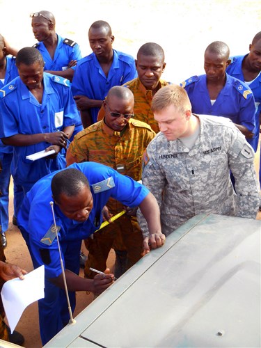 1st Lt. Robert Hundemer observes a Burkinabe student taking a measurement during a center of balance practical exercise. Hundemer and Sgt. 1st. Class Jeff Wernholm are part of the 299th Brigade Support Battalion from Fort Riley, Kan. They worked as a U.S. Army Africa-led, two-man Africa Deployment Assistance Partnership Team - Ground or ADAPT-G in Ouagdougou, Burkina Faso. The pair assisted 23 Burkinabe Armed Forces students to learn how to build deployment capacity for conducting peacekeeping, counterterrorism or humanitarian relief operations. (U.S. Army Africa photo by Capt. Theresa Giorno)