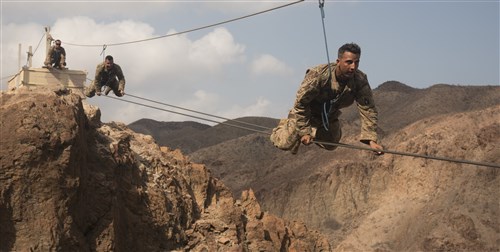 ARTA PLAGE, Djibouti – U.S. Army Soldiers from the 1st Battalion, 124th Infantry Regiment, assigned to Combined Joint Task Force-Horn of Africa, make their way across a portion of the mountain obstacle course, as part of the final day of the French Marines Desert Survival Course, Oct. 10, 2016, at Arta Plage, Djibouti. Approximately 46 U.S. Army Soldiers with French Marines completed several tasks during the survival course, including desert operations, combat lifesaving skills, weapons training, survival cooking, how to decontaminate water, and water and mountain obstacle courses. (U.S. Air Force photo by Staff Sgt. Tiffany DeNault)