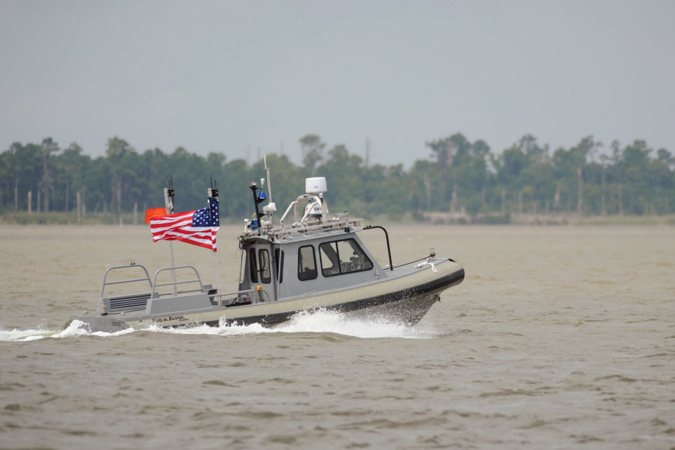 NEWPORT NEWS, Va. (Aug. 12, 2014) An unmanned 27-foot harbor security boat from Naval Surface Warfare Center Carderock operates autonomously during an Office of Naval Research-sponsored demonstration of swarmboat technology on the James River in Newport News, Va. During the demonstration as many as 13 Navy boats, using an Office of Naval Research-sponsored system called CARACaS (Control Architecture for Robotic Agent Command Sensing), operated autonomously or by remote control during escort, intercept and engage scenarios. U.S. Navy photo by John F. Williams. 
