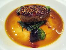 plate of Foie gras with mustard seeds and green onions on yellow plate