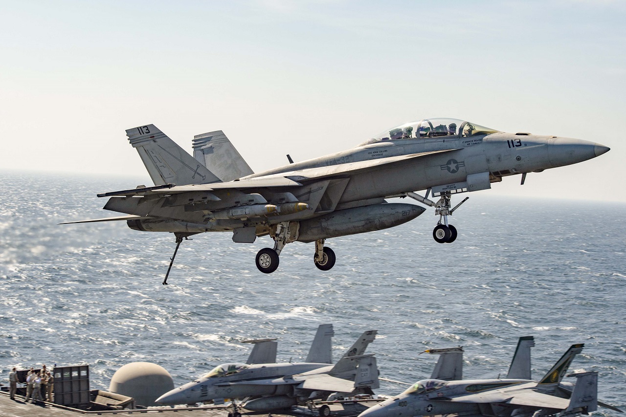 An F/A-18-F Super Hornet assigned to the Fighting Swordsmen of Strike Fighter Squadron 32 flies across the flight deck of the aircraft carrier USS Dwight D. Eisenhower in the Arabian Gulf, Nov. 10, 2016. The Eisenhower and its carrier strike group are deployed in support of Operation Inherent Resolve, maritime security operations and theater security cooperation efforts in the U.S. 5th Fleet area of operations. OIR’s mission to counter the Islamic State of Iraq and the Levant is one of the Defense Department’s five evolving challenges, as discussed in a House Permanent Select Committee on Intelligence hearing with DoD and intelligence officials, Nov. 17, 2016. Navy photo by Petty Officer 3rd Class Nathan T. Beard 