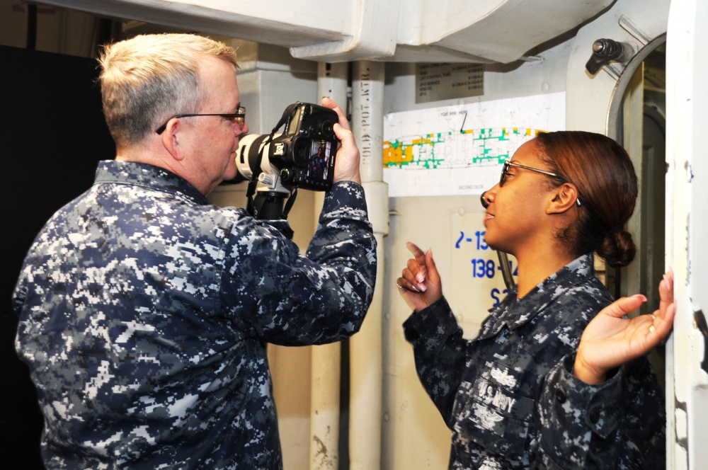 Norfolk, VA (Feb. 24, 2015) Mass Communications Specialist Senior Chief Gary Ward, left, previews a photo with Gunner's Mate 2nd Class Rebekah Rahn, from Atlanta, as part of a fleet hometown news interview aboard the aircraft carrier USS George H.W. Bush (CVN 77). George H.W. Bush is conducting training exercises in its homeport. U.S. Navy photo by Mass Communication Specialist 3rd Class Lorelei Vander Griend.