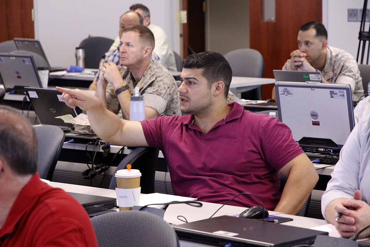 Michael Martha, systems engineer with Marine Corps Systems Command participates in class discussion during a modeling and simulation course aboard Marine Corps Base Quantico. Those who completed the course received 40 continuous learning points-essentially a year's worth of training-emerging ready to take the Certified Modeling and Simulation Professional exam. U.S. Marine Corps photo by Jim Katzaman 

