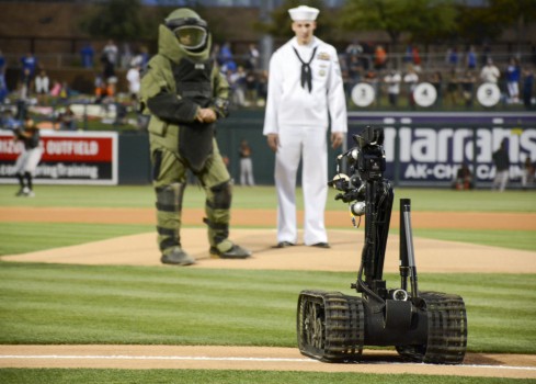 A Talon bomb disposal robot brings out the ball for the first pitch at a spring training baseball game between the Los Angeles Dodgers and San Francisco Giants as part of the Phoenix Navy Week. Rear Adm. Yancy Lindsey, USS Constitution Sailors, Explosive Ordinance Mobile Unit 3, Navy Band Southwest, USS Oscar Austin Sailors, Navy Recruiting District Phoenix and the Navy ceremonial guard silent drill team are all in Phoenix to promote the Navy in an area where there isn’t a large Navy presence. U.S. Navy photo by Mass Communication Specialist Seaman Mickey Treigle 