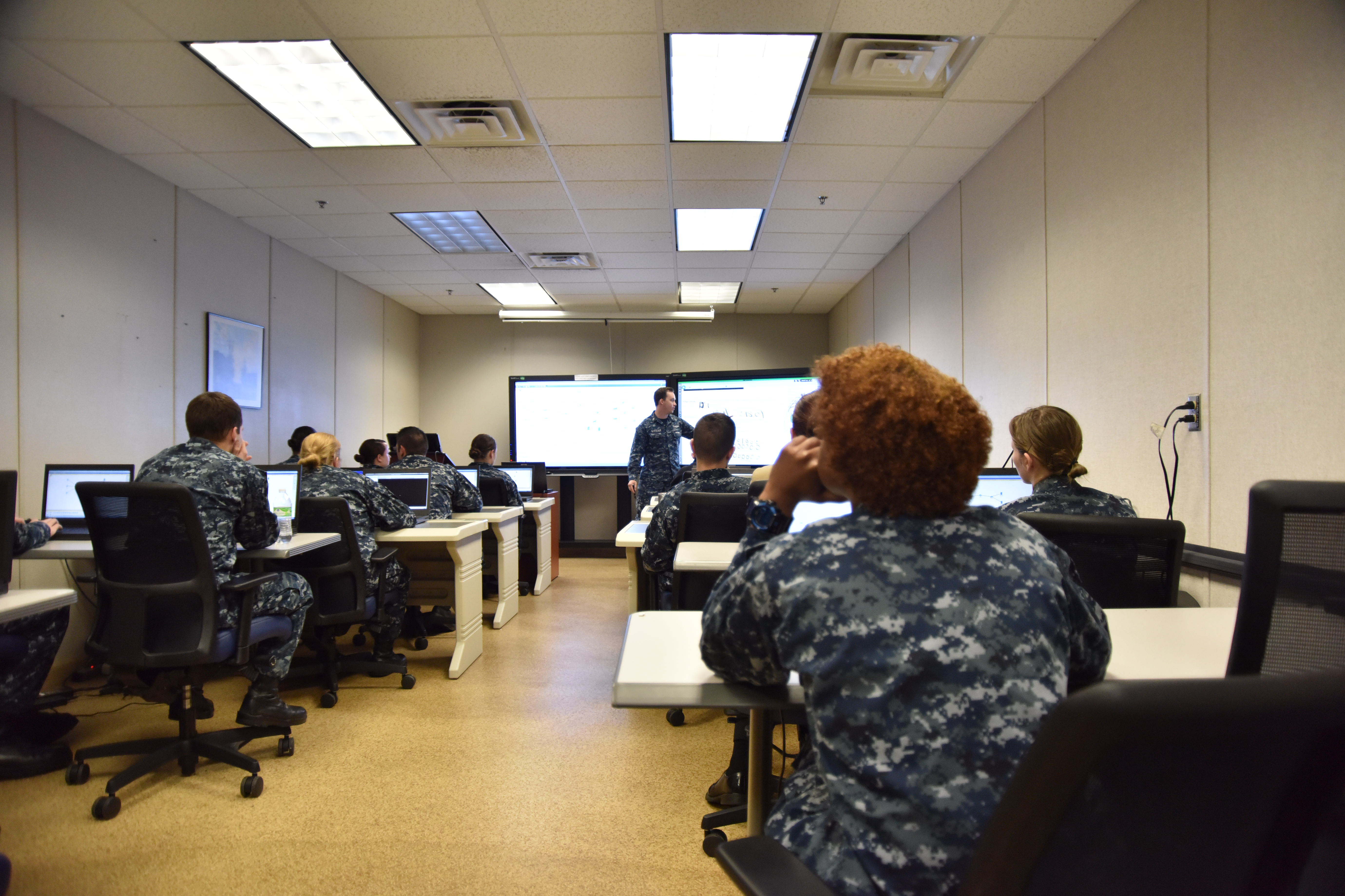 IT1 Jacob Barteaux (center) provides cyber security training to CNTT students during the first course with NIOC Norfolk's revised curriculum. Photo courtesy of U.S. Navy by IT2 (IDW) Deveion R. Acker.