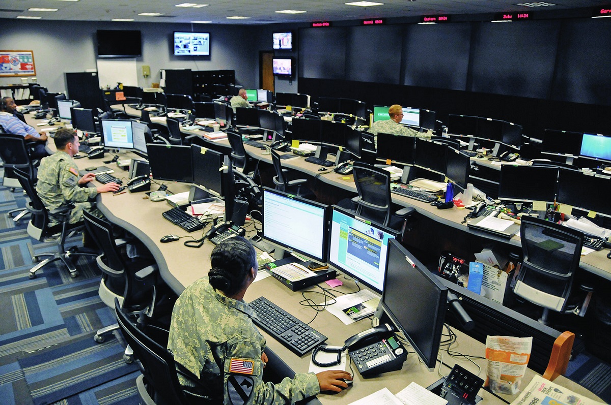 Uniformed and civilian cyber and military intelligence specialists monitor Army networks in the Cyber Mission Unit’s Cyber Operations Center at Fort Gordon, Ga. U.S. Army photo by Michael L. Lewis