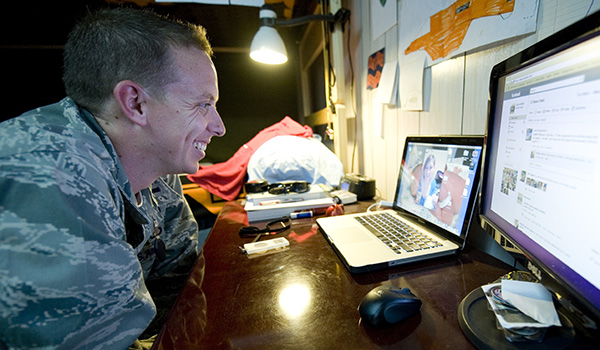 U.S. Air Force 1st Lt. Arthur Litchfield speaks to his wife, Desiree, as she holds the newest addition to their family. Litchfield, who was deployed in Iraq, was able to watch the whole birth over the Internet. U.S. Air Force photo by Staff Sgt. Levi Riendeau.