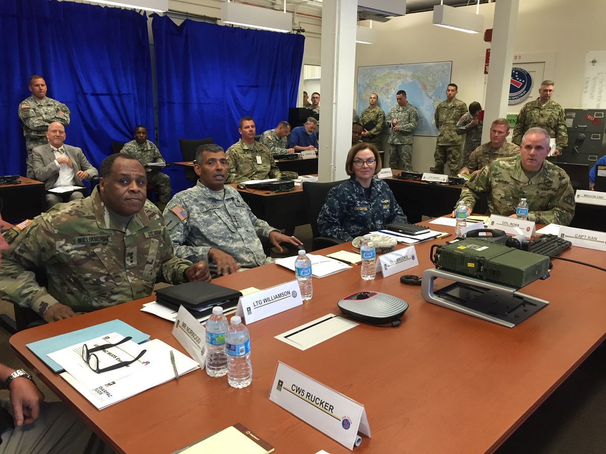 (From left to right) Lt. Gen. Michael Williamson, Principal Military Deputy to the Assistant Secretary of the Army (Acquisition, Logistics and Technology), Gen. Vincent Brooks, U.S. Army, Pacific Command (USARPAC), Rear Admiral Kathy Creighton, U.S. Pacific Command J6 and Col. James Ross, Project Manager Tactical Radios attended the USARPAC exercise held in Hawaii on Feb. 18. Using the Army's Manpack Radio and the Navy's Mobile User Objective System (MUOS) waveform, the exercise highlighted how Soldiers on land and at sea were able to talk, text, share data and track the progress of a Logistics Supply Vessel as it moved between islands. Photo Credit: Kyle Bond