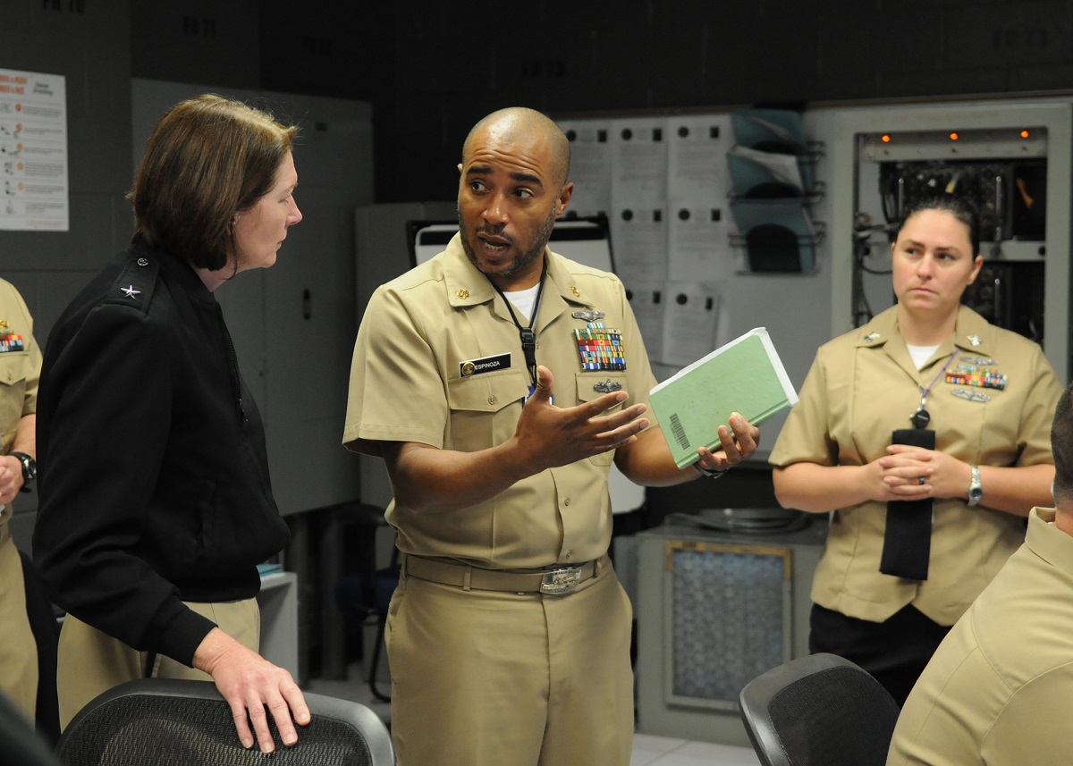 PENSACOLA, Fla. (Jan. 15, 2016) Chief Cryptologic Technician (Technical) Valentino Espinoza discusses electronic warfare training with Rear Adm. Nancy A. Norton, director of Warfare Integration for Information Dominance (OPNAV N2/N6F), at the Center for Information Dominance Unit Corry Station. Norton visited training and operational commands for the information warfare community in Pensacola.  U.S. Navy photo by Carla M. McCarthy 