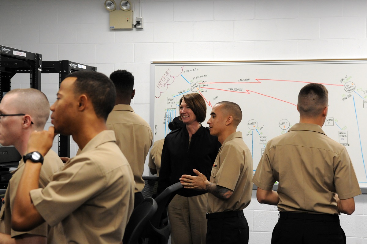 PENSACOLA, Fla. (Jan. 15, 2016) Rear Adm. Nancy A. Norton, director of Warfare Integration for Information Dominance (OPNAV N2/N6F), discusses information systems technician training with students at the Center for Information Dominance Unit Corry Station. The students were setting up a mock shipboard network as part of a capstone exercise.  U.S. Navy photo by Carla M. McCarthy 