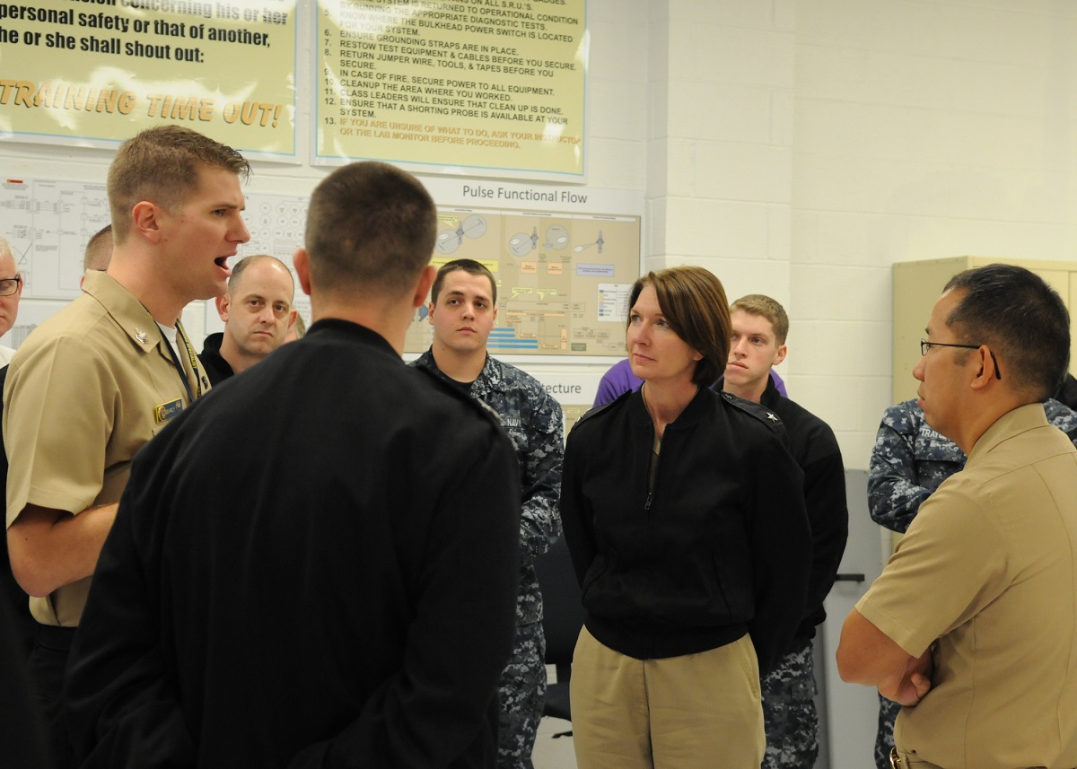 PENSACOLA, Fla. (Jan. 15, 2016) Rear Adm. Nancy A. Norton, director of Warfare Integration for Information Dominance (OPNAV N2/N6F), discusses information warfare community training with instructors at the Center for Information Dominance Unit Corry Station.  U.S. Navy photo by Carla M. McCarthy 