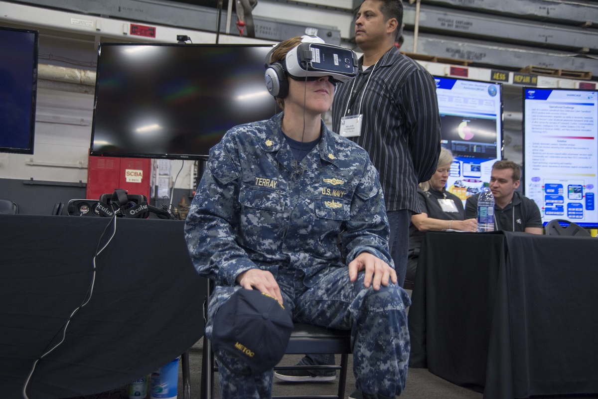 SAN DIEGO (March 16, 2016) Lt. Cmdr. Allison Terray tries a virtual reality headset at the Innovation Jam hosted aboard Wasp-class amphibious assault ship USS Essex (LHD 2). Commander, U.S. Pacific Fleet's (PACFLT) Bridge Program welcomes the Space and Naval Warfare Systems Center Pacific (SSC Pacific) Innovation Jam, sponsored by OPNAV N4 Fleet Readiness and Logistics and the Office of Naval Research. The Innovation Jam showcase pioneering concepts and rapid solutions to the fleet by SSC Pacific, the Athena Project, Tactical Advancements for the Next Generation and the Hatch. Solutions to Fleet-centric war fighting challenges are showcased by some of the bright and creative PACFLT Sailors. One of the bright ideas will be selected for initial funding, development, prototyping and possible transition to Fleet-wide implementation. U.S. Navy Photo by Mass Communication Specialist 2nd Class Molly A. Sonnier 
