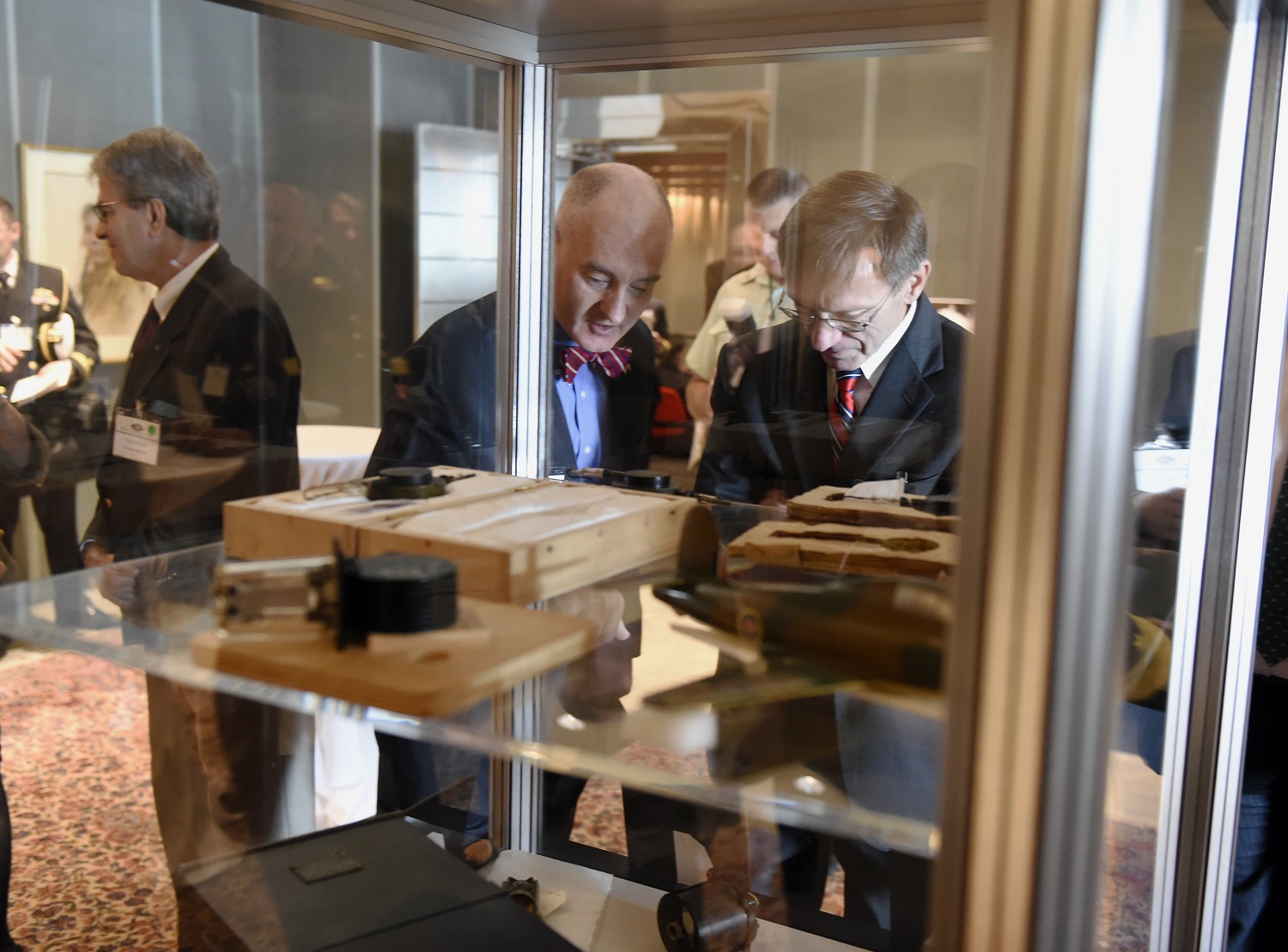 Dr. Larry Schuette, left, director, Office of Research (Discovery and Invention), discusses artifacts on display during the 75th-anniversary commemoration of the Tizard Mission with Sean J. Stackley, assistant secretary of the Navy for research, development and acquisition, during an event held at the Canadian Embassy in Washington, D.C. In 1940, Sir Henry Tizard and a small British delegation brought with them to the United States and Canada plans for more than 20 technologies, most importantly the cavity magnetron, which made possible radars that were both small and powerful. U.S. Navy photo by John F. Williams 
