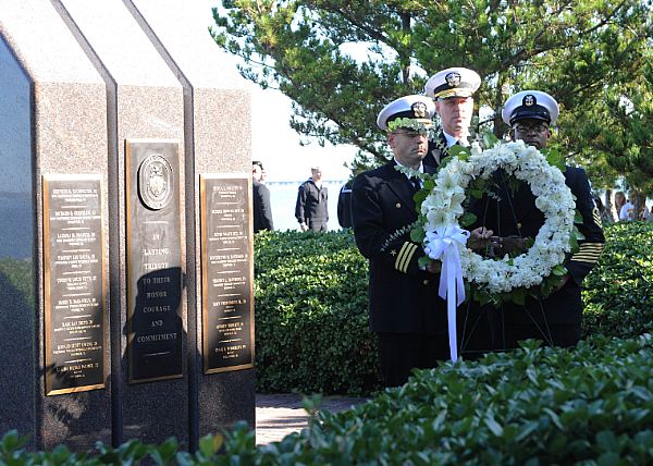 NORFOLK (Oct. 12, 2015) Rear Adm. Christopher W. Grady, Cmdr. James Quaresimo and Command Master Chief Michael Fisher carry a wreath at the USS Cole Memorial during a ceremony at Naval Station Norfolk. This ceremony commemorates the 15-year anniversary of the Oct.12, 2000 terrorist attack on the guided-missile destroyer USS Cole (DDG 67). U.S. Navy photo by Mass Communication Specialist 3rd Class Amber Donnelly.