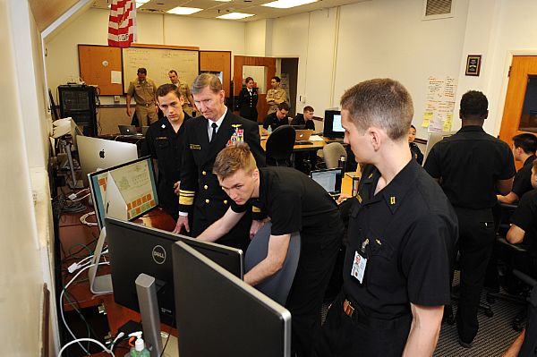 ANNAPOLIS, Md. (April 15, 2015) Vice Adm. Walter E. Carter, superintendent of the U.S. Naval Academy, observes a team of midshipmen during the 15th annual Cyber Defense Exercise hosted by the National Security Agency. U.S. Navy photo by Mass Communication Specialist 2nd Class Tyler Caswell.