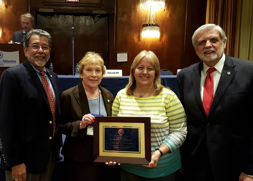 ATLANTA, Ga. (Nov. 4, 2015) Instructional Systems Specialist Denise Myers, liaison between the Center for Information Dominance (CID) and the Council on Occupational Education (COE), second from right, accepts a plaque on behalf of CID's staff recognizing 40 years of accreditation with COE.   The accreditation provides quality assurance reviews of career and technical workforce training programs. (Courtesy photo)