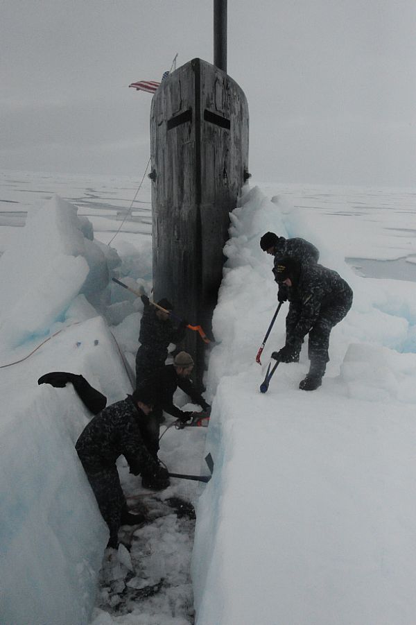 ARCTIC OCEAN (July 30, 2015) Sailors aboard the fast attack submarine USS Seawolf (SSN 21) remove arctic ice from the hull after surfacing at the North Pole. Seawolf conducted routine Arctic operations. Photo courtesy of U.S. Navy.