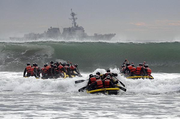 CORONADO, Calif. (Jan. 21, 2014) Basic Underwater Demolition/SEAL (BUDs) students participate in Surf Passage at Naval Amphibious Base Coronado. Surf Passage is one of many physically demanding evolutions that are a part of the first phase of SEAL training. Navy SEALs are the maritime component of U.S. Special Forces and are trained to conduct a variety of operations from the sea, air and land. U.S. Navy photo by Mass Communication Specialist 1st Class Michael Russell.