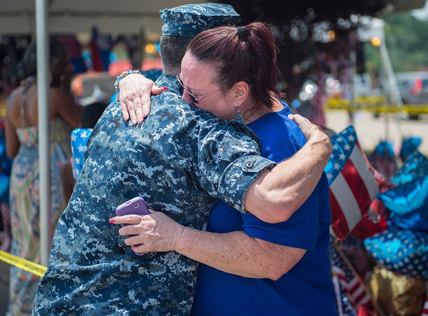 A Sailor comforts a woman in Chattanooga during the memorial service for the victims of the July 16 shooting. U.S. Navy photo by Mass Communication Specialist 2nd Class Justin Wolpert.