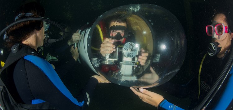 WEST BETHESDA, Md. (June 22, 2015) Students from Texas A&M University perform an underwater inspection before racing their human powered submarine during the International Submarine Races.  U.S. Navy photo by Mass Communication Specialist 2nd Class Wyatt Huggett.