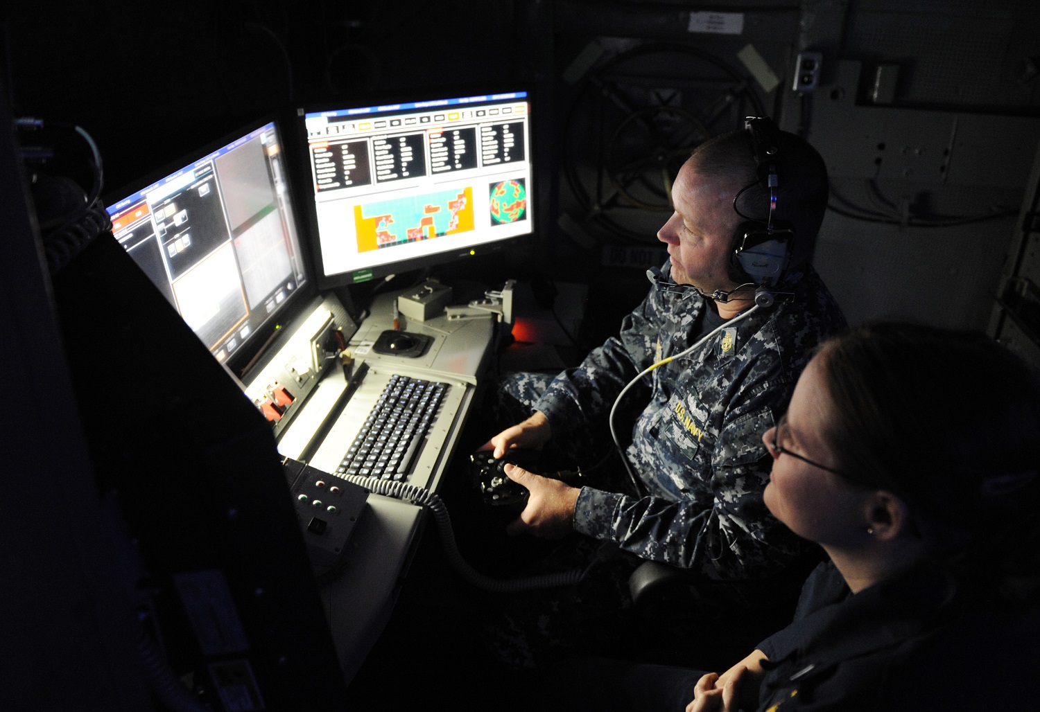 ARABIAN GULF (Nov. 16, 2014) Chief Fire Controlman Brett Richmond and Lt. j.g. Katie Woodard operate the Office of Naval Research (ONR)-sponsored Laser Weapon System (LaWS) installed aboard the Afloat Forward Staging Base (Interim) USS Ponce (ASB(I) 15) during an operational demonstration in the Arabian Gulf. Directed energy weapons can counter asymmetric threats, including unmanned and light aircraft and small attack boats. U.S. Navy photo by John F. Williams.