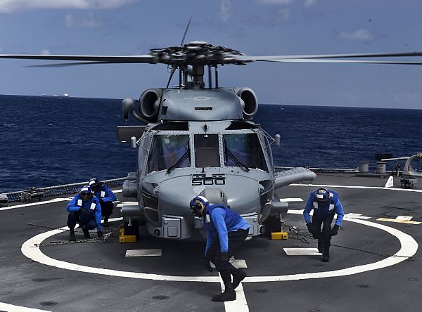 ATLANTIC OCEAN (April 3, 2015) Sailors secure an MH-60R Sea Hawk helicopter attached to the Vipers of Helicopter Maritime Strike Squadron (HSM) 48 to the flight deck of the guided-missile destroyer USS Porter (DDG 78). Porter transits to Scotland to participate in Joint Warrior, a United Kingdom-led semi-annual multinational cooperative training exercise. U.S. Navy photo by Mass Communication Specialist Seaman Ryan U. Kledzik.