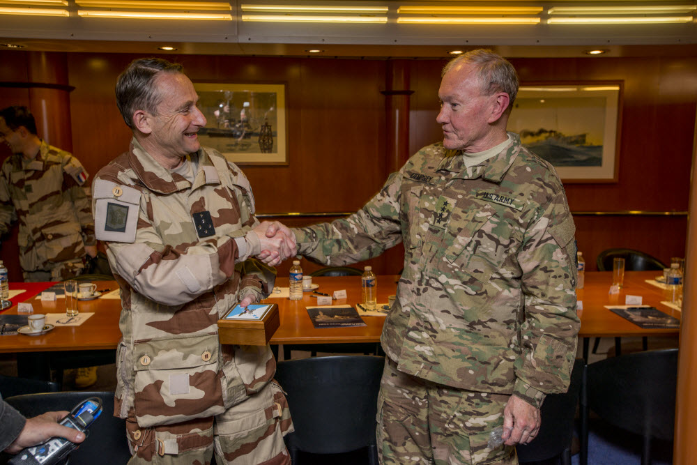 ARABIAN GULF (March 8, 2015) Chairman of the Joint Chiefs of Staff Gen. Martin Dempsey, right, shakes hands with French Chief of Defense Staff Gen. Pierre De Villiers during a gift exchange aboard the French navy aircraft carrier Charles de Gaulle (R 91). Charles de Gaulle is operating with the Carl Vinson Carrier Strike Group in the U.S. 5th Fleet area of responsibility. U.S. Navy photo by Mass Communication Specialist 2nd Class John Philip Wagner, Jr. 