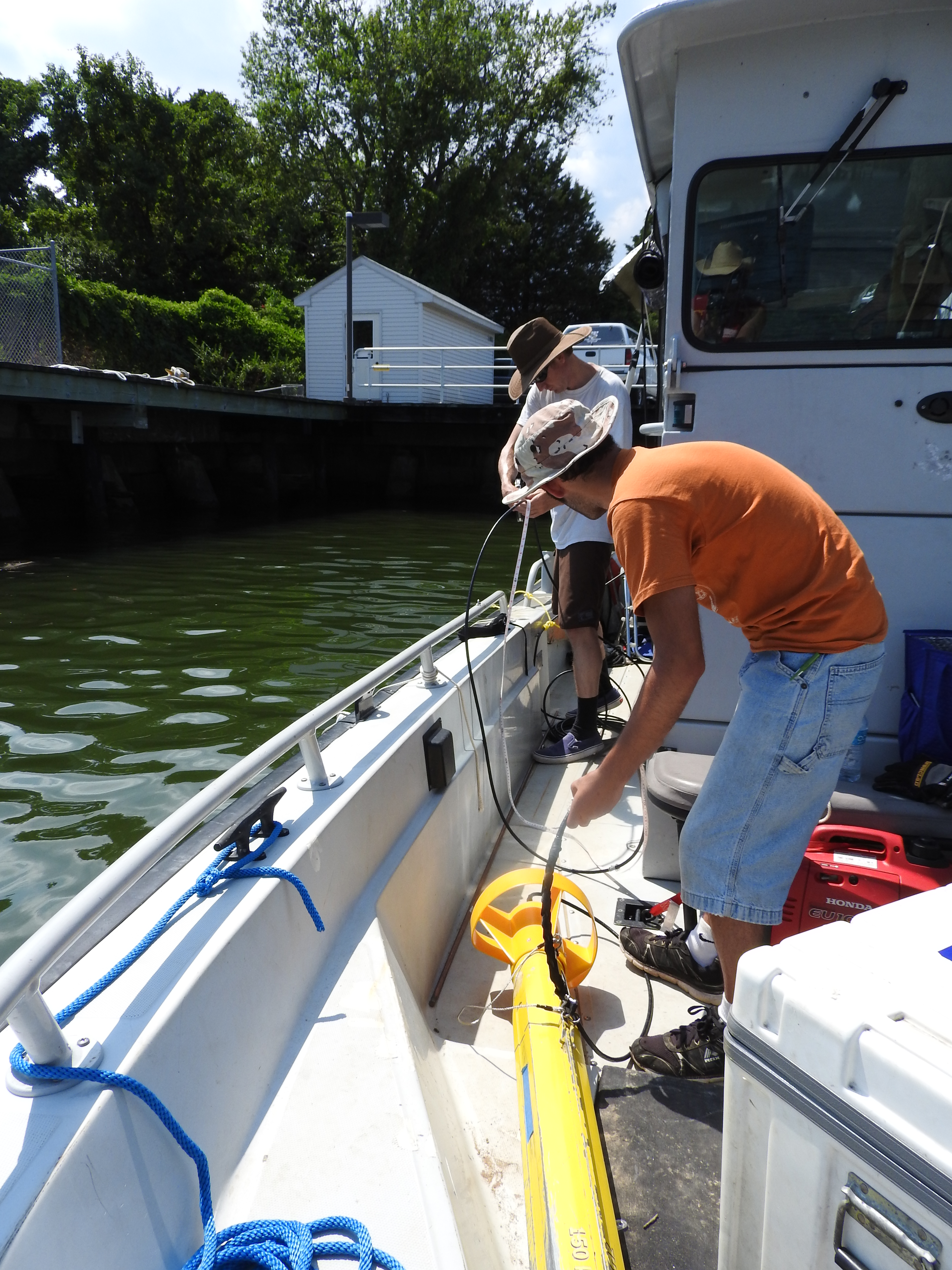 Not your normal type of fish: This yellow tow fish uses sonar to map the sea floor in real time to help locate historic craft. George Schwarz (back)/Agustin Ortiz (front). NHHC photo by Blair Atcheson.