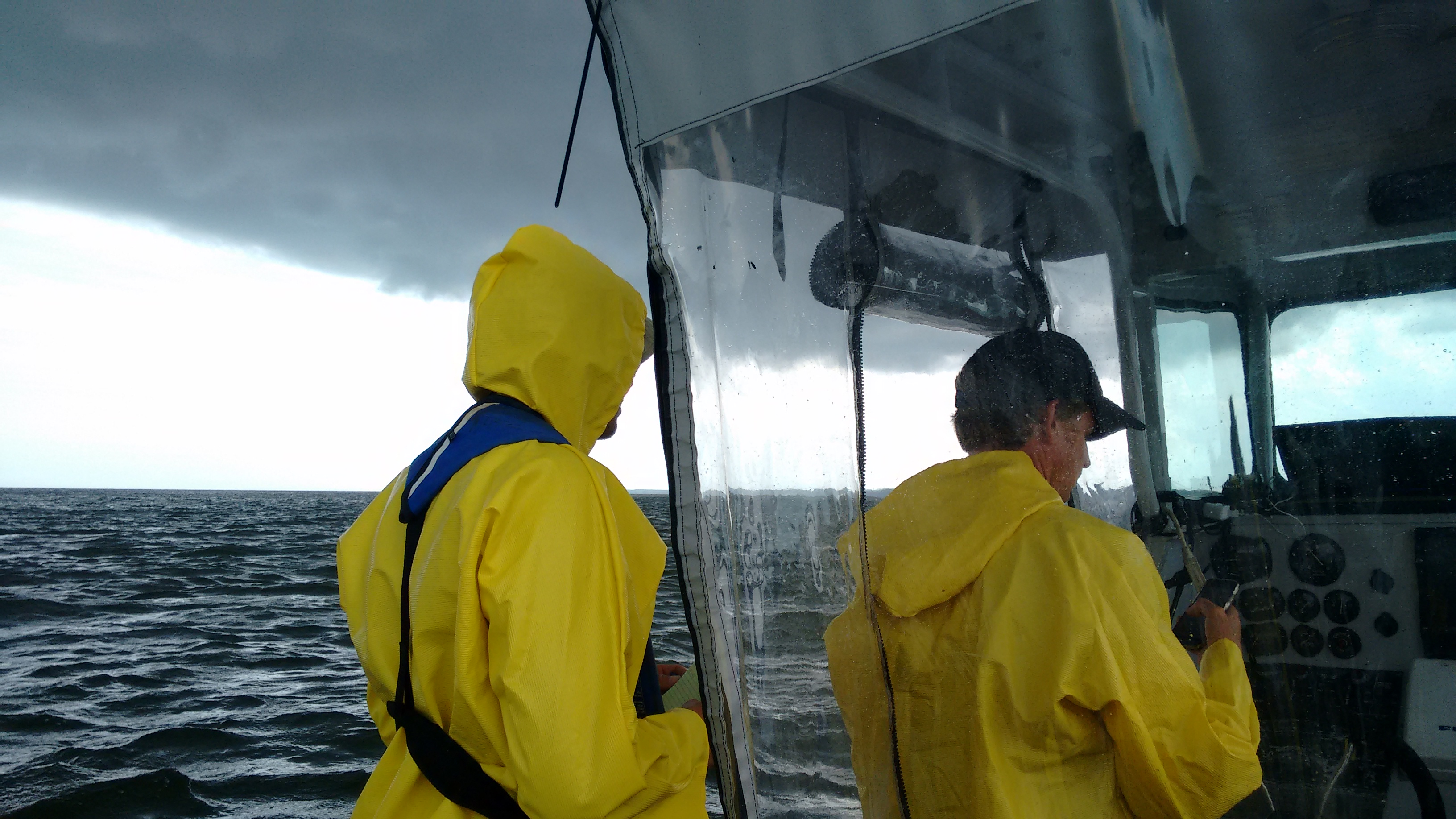 August 01, 2016: Storms are just one of the challenges NHHC archaeologist face when performing survey work on the Chesapeake. Silas Dean (left)/George Schwarz (right). NHHC photo by Heather Brown.