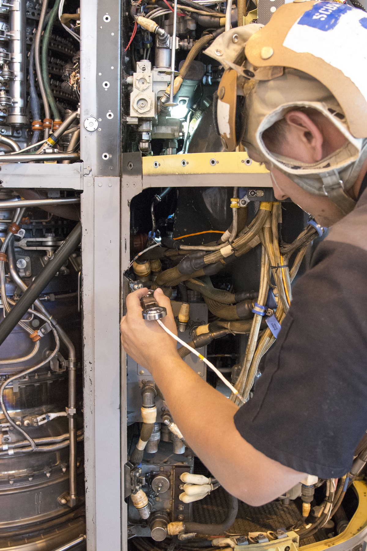 PATUXENT RIVER NAVAL AIR STATION, Md. (July 28, 2016) Aviation Mechanic Cody Schwarz works to install a 3-D printed titanium link and fitting on an MV-22B Osprey engine nacelle on July 28 at Patuxent River Naval Air Station, Md. Schwarz can be seen holding the link prior to affixing it to the aircraft.  U.S. Navy photo/Released 