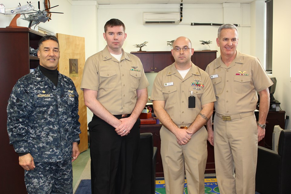 Capt. Joe Rodriguez (left), commander, Fleet Readiness Center Mid-Atlantic (FRCMA) congratulates Petty Officer Richard Walsh (second from left) and Senior Chief Ryan Balzer (second from right) on their receiving a Secretary of the Navy (SECNAV) 2015 Innovation Award. Also on hand to extend his congratulations was Capt. Keith Nixon (right), FRCMA executive officer. U.S. Navy photo 