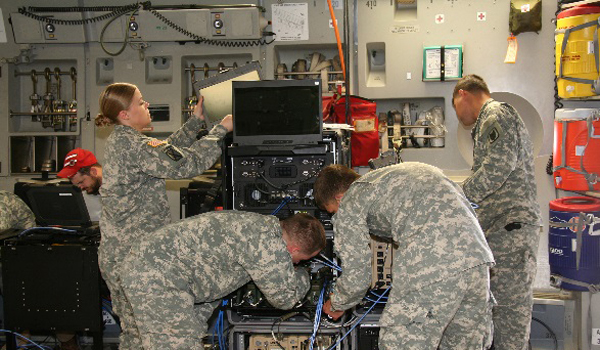 Soldiers configure the communications systems housed within ruggedized transit cases to allow in-flight secure network access and mission command for increased situational awareness, as part of the Enroute Mission Command Capability (EMC2) demonstration on May 14, 2015 at Pope Army Air Field, Fort Bragg, N.C. U.S. Army photo by Amy Walker, PEO C3T 