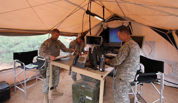 Soldiers with the 1st Squadron, 1st Cavalry Regiment Main plan their mission from inside the Lightweight Mobile Command Post TAC during the Network Integration Evaluation/Army Warfighter Assessments, or NIE/AWA, 16.1. The TAC is an integrated HUMVEE that includes a quick erect table and large screen display, which are key timesaving enablers for setup and teardown of the command post. The L-MCP is one component the Expeditionary Command Post, or ECPC, technology demonstrator. U.S. Army CERDEC photo by Edric Thompson