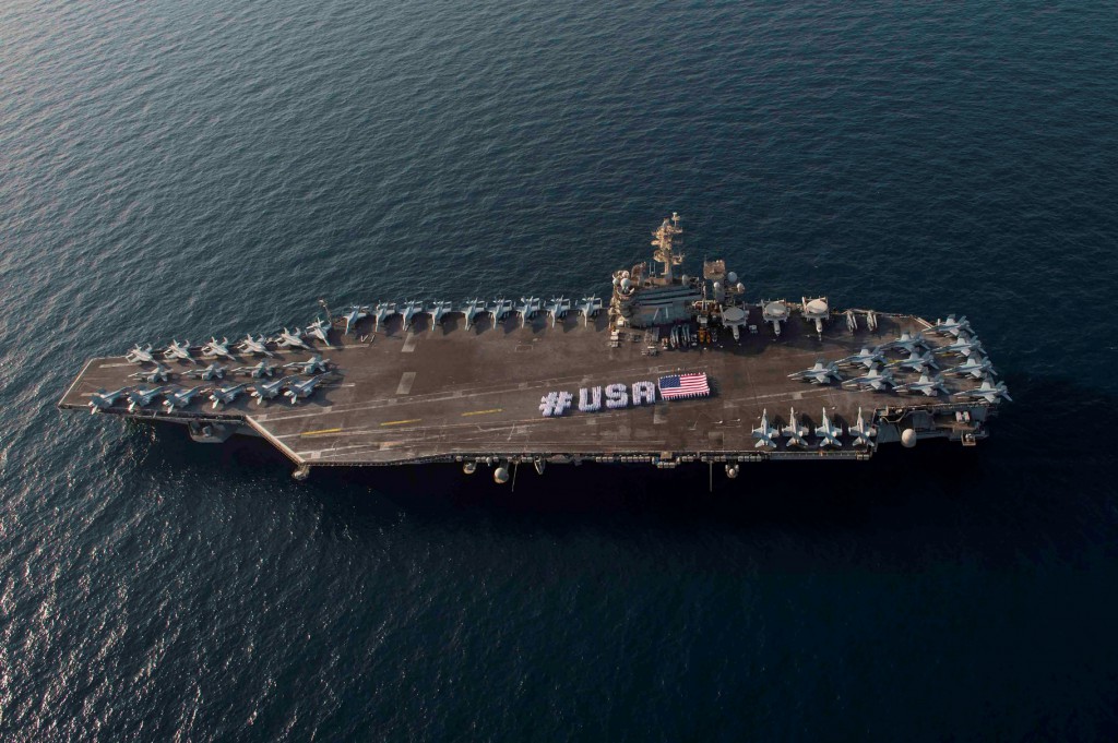 ARABIAN GULF (June 28, 2015) Sailors spell out #USA with the American flag on the flight deck of the aircraft carrier USS Theodore Roosevelt in honor of the Independence Day weekend. U.S. Navy photo