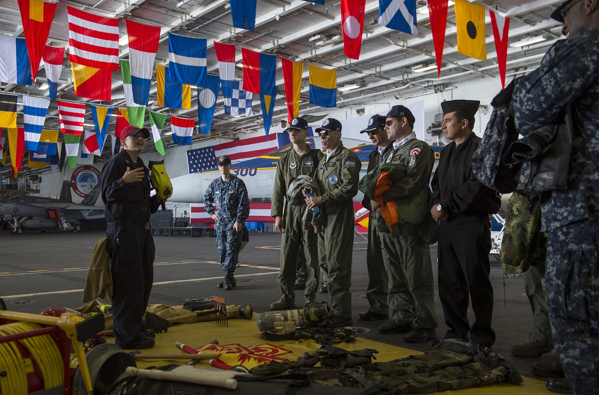VALPARAISO, Chile (Oct. 23, 2015) Damage Controlman 3rd Class Patricia Johnston explains firefighting equipment usage to guests in the hangar bay of aircraft carrier USS George Washington (CVN 73) during a distinguished visitor embark. UNITAS 2015, the U.S. Navy's longest running annual multinational maritime exercise, is part of the Southern Seas deployment planned by U.S. Naval Forces Southern Command/U.S. 4th Fleet. This 56th iteration of UNITAS is conducted in two phases: UNITAS PACIFIC, hosted by Chile, Oct. 13-24, 2015 and UNITAS Atlantic, hosted by Brazil scheduled for November. U.S. Navy photo by Mass Communication Specialist 3rd Class Bryan Mai 