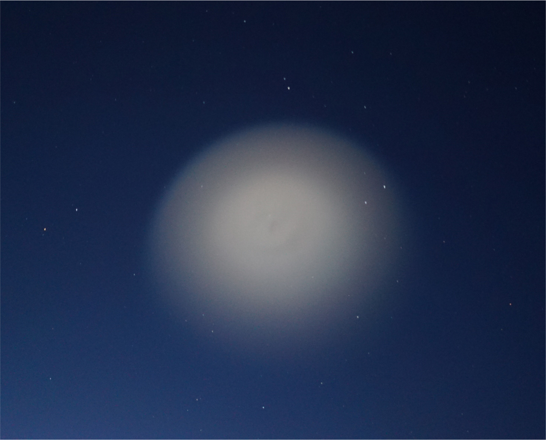 An Image of the Charged Aerosol Release Experiment (CARE II) dust cloud as observed from a NASA B200 aircraft using a Sony Alpha7S camera. The cloud shows an upward hemispherical expansion of the dust 45 seconds after ignition of the CARE II dust release designed by NRL and NASA/Wallops. The NASA/Wallops aircraft supported five camera systems provided by the Naval Research Laboratory, SRI International, University of Maryland, and NASA Goddard Space Flight Center. Photo courtesy of the University of Washington by Todd Anderson and SRI by Asti Bhatt.