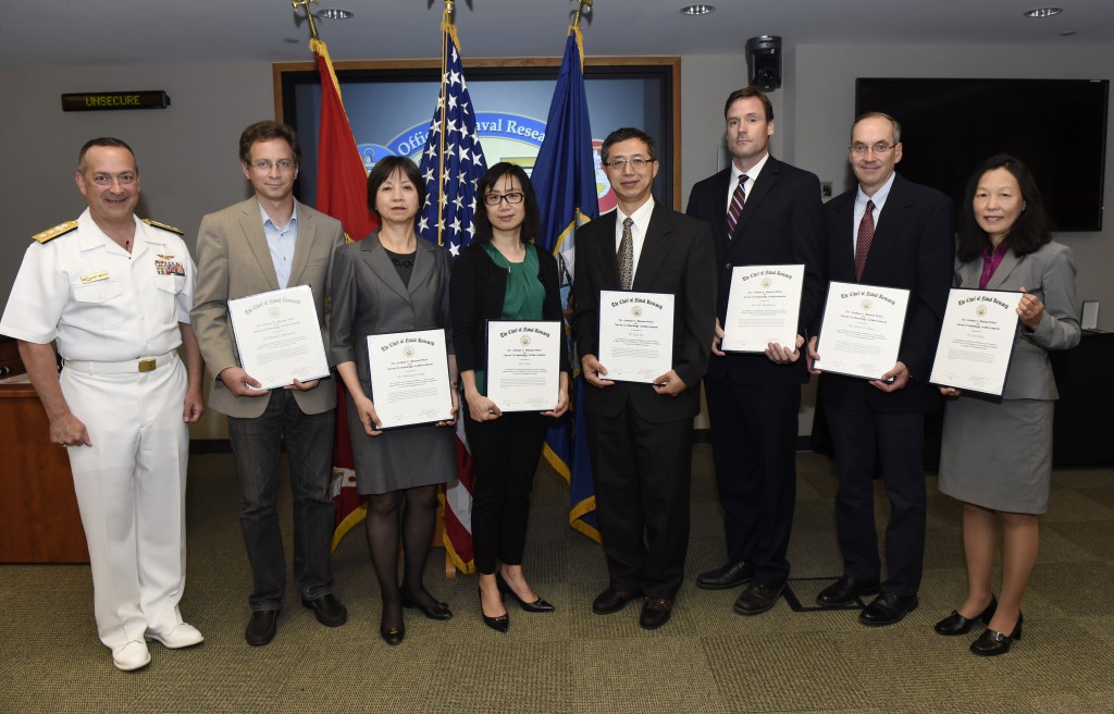 ARLINGTON, Virginia (August 26, 2015) Rear Adm. Mat Winter, chief of naval research, presents the Dr. Arthur E. Bisson Award for Naval Technology Achievement to, from left, Dr. Patrick Reinecke, Dr. Melinda Peng, Dr. Yi Jin, Dr. Hao Jin, Dr. Eric Hendricks, Dr. James Doyle, and Dr. Sue Chen, during a honorary awards ceremony held at the Office of Naval Research in Arlington, Va. U.S. Navy photo by John F. Williams