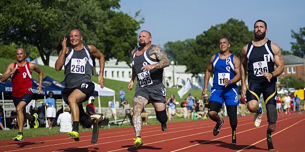 QUANTICO, Va. (June 23, 2014) Members of various teams participate in the 100-meter sprint during the 2015 Department of Defense Warrior Games at Butler Stadium at Marine Corps Base Quantico, Va. The Warrior Games, founded in 2010, is a Paralympic-style competition that features eight adaptive sports for wounded, ill, and injured service members and veterans from the U.S. Army, Marine Corps, Navy, Coast Guard, Air Force, Special Operations Command, and the British Armed Forces. This year marks the first time the Department of Defense takes responsibility for operational planning and coordination of the event, in which approximately 250 athletes are expected to compete. U.S. Marine Corps photo by Lance Cpl. Terry W. Miller Jr.