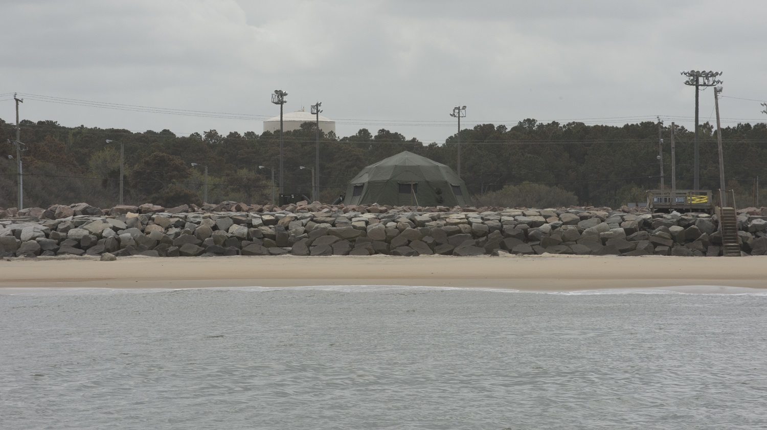 A land-based tactical operations center on the beach at Joint Expeditionary Base Little Creek-Fort Story, Va., April 21, 2015. The tactical operations center was part of a capability demonstration April 13-24. Navy personnel and private industry were testing the line-of-sight radio and satellite network capabilities from the tactical operations to the littoral operations center aboard Stiletto. U.S. Navy photo by Devin Pisner.