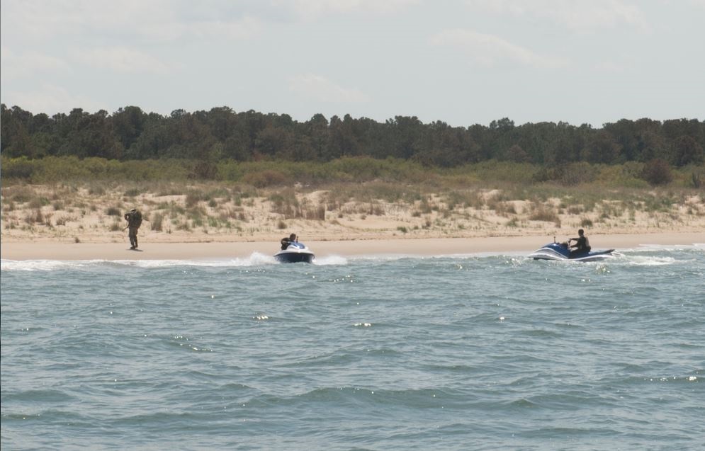 Jet-skis were used to transfer the high value target to the beach for system developers aboard the Stiletto vessel to track the target’s location to capture the threat off the Virginia coast near Joint Expeditionary Base Little Creek-Fort Story, April 22, 1015. The Stiletto Maritime Demonstration and CNO’s Rapid Innovation Cell conducted a two-week Capability Demonstration to assess new concepts for command and control and multi-sensor fusion technologies for small vessels. Two scenarios were conducted daily to demonstrate how the Adaptive Force Package Littoral Operations Center (AFP LOC) will help optimize command and control capabilities: a high-value target interdiction scenario and a humanitarian assistance disaster relief scenario. To test rapid reconfigurability, the AFP LOC shifted between these drastically different mission sets within an hour. U.S. Navy photo by Nicholas Malay.