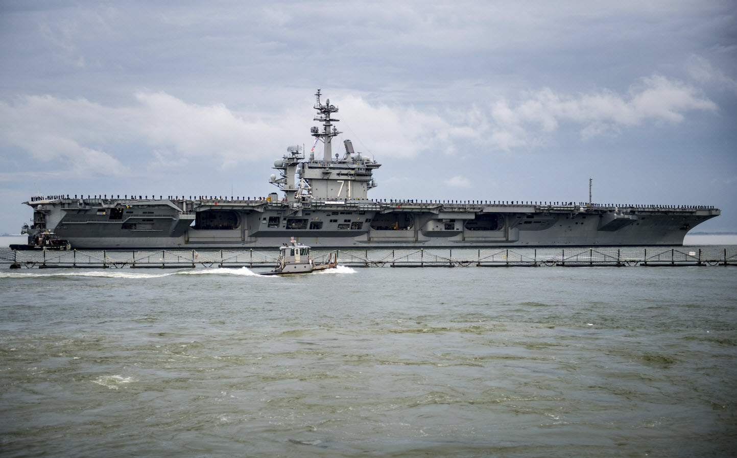 NORFOLK (March 11, 2015) The aircraft carrier USS Theodore Roosevelt (CVN 71) departs Naval Station Norfolk for a scheduled deployment. The deployment is part of a regular rotation of forces to support maritime security operations, provide crisis response capability, and increase theater security cooperation and forward naval presence in the 5th and 6th Fleet areas of operation. U.S. Navy photo by Mass Communication Specialist 2nd Class Justin Wolpert.