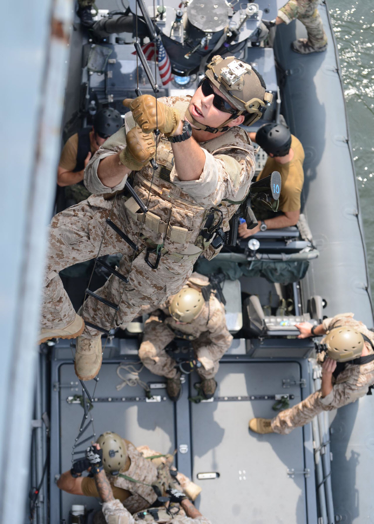 VIRGINIA BEACH, Va. (July 16, 2013) U.S. Navy SEALs (Sea, Air, and Land) climb a caving ladder during visit, board, search and seizure (VBSS) training on Joint Expeditionary Base Little Creek-Fort Story. Navy SEALs are the maritime component of U.S. Special Forces and are trained to conduct missions from sea, air, and land. U.S. Navy photo by Mass Communication Specialist 2nd Class.