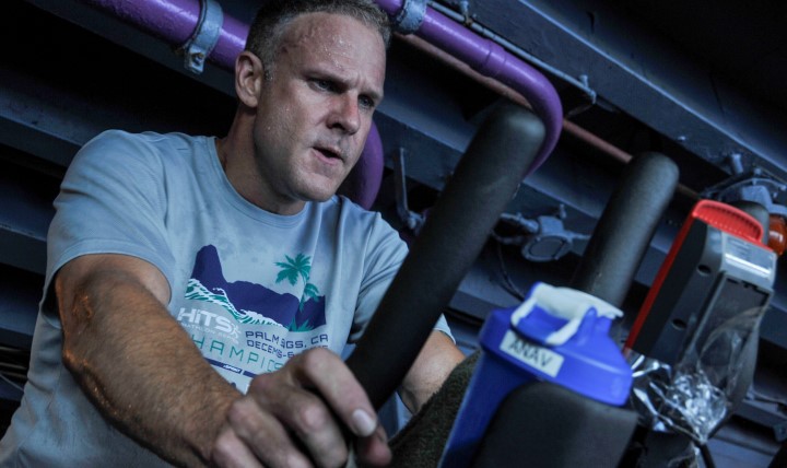 Navy Lt. Cmdr. Brian Conner, assistant navigator aboard the aircraft carrier USS George Washington, works out on the ship. (U.S. Navy photo by Mass Comunication Specialist 3rd Class Kashif Basharat)