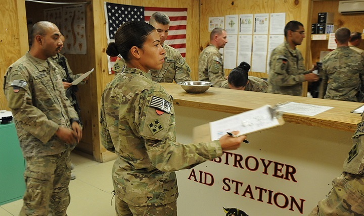 Army Sgt. Liliane Milo, a medic with 4th Infantry Division, checks in Soldiers for Military Acute Concussion Evaluations.