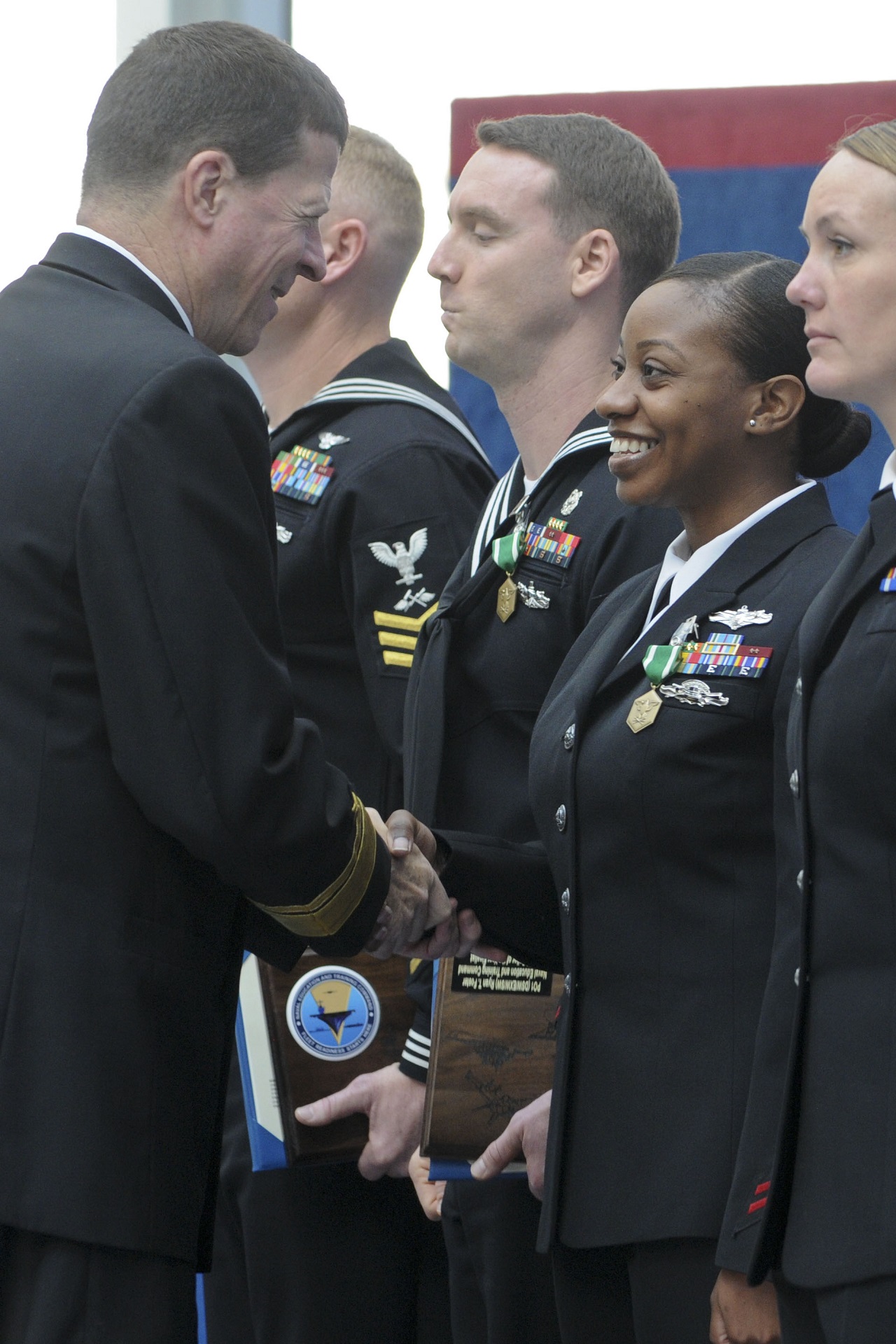 PENSACOLA, Fla. (Dec. 15, 2016) Rear Adm. Michael White, commander, Naval Education and Training Command (NETC), presents a Navy and Marine Corps Commendation Medal to Petty Officer 1st Class Kayshonda London from Center for Information Warfare Training Detachment Fort Gordon, Georgia, during this year's NETC Sailor and Instructor of the Year awards ceremony. London, of Fayetteville, North Carolina, was a Sailor of the Year finalist. U.S. Navy photo by Carla M. McCarthy/Released