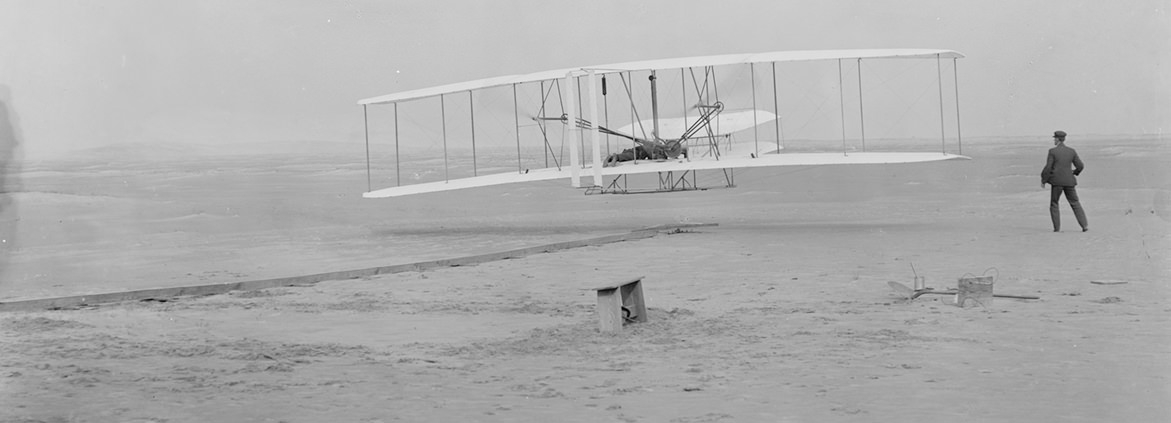 This photograph shows the first powered, controlled, sustained flight. Orville Wright at the controls of the machine, lying prone on the lower wing with hips in the cradle which operated the wing-warping mechanism. Wilbur Wright running alongside to balance the machine, has just released his hold on the forward upright of the right wing. Today, we fly using technological advances that the Wright Brothers only could have imagined. Millions of people board airplanes, confident that pilots will guide them safely to their destinations. But safe navigation begins well before the pilot even touches the plane's controls; it begins with the runway. That's where NOAA comes in.
